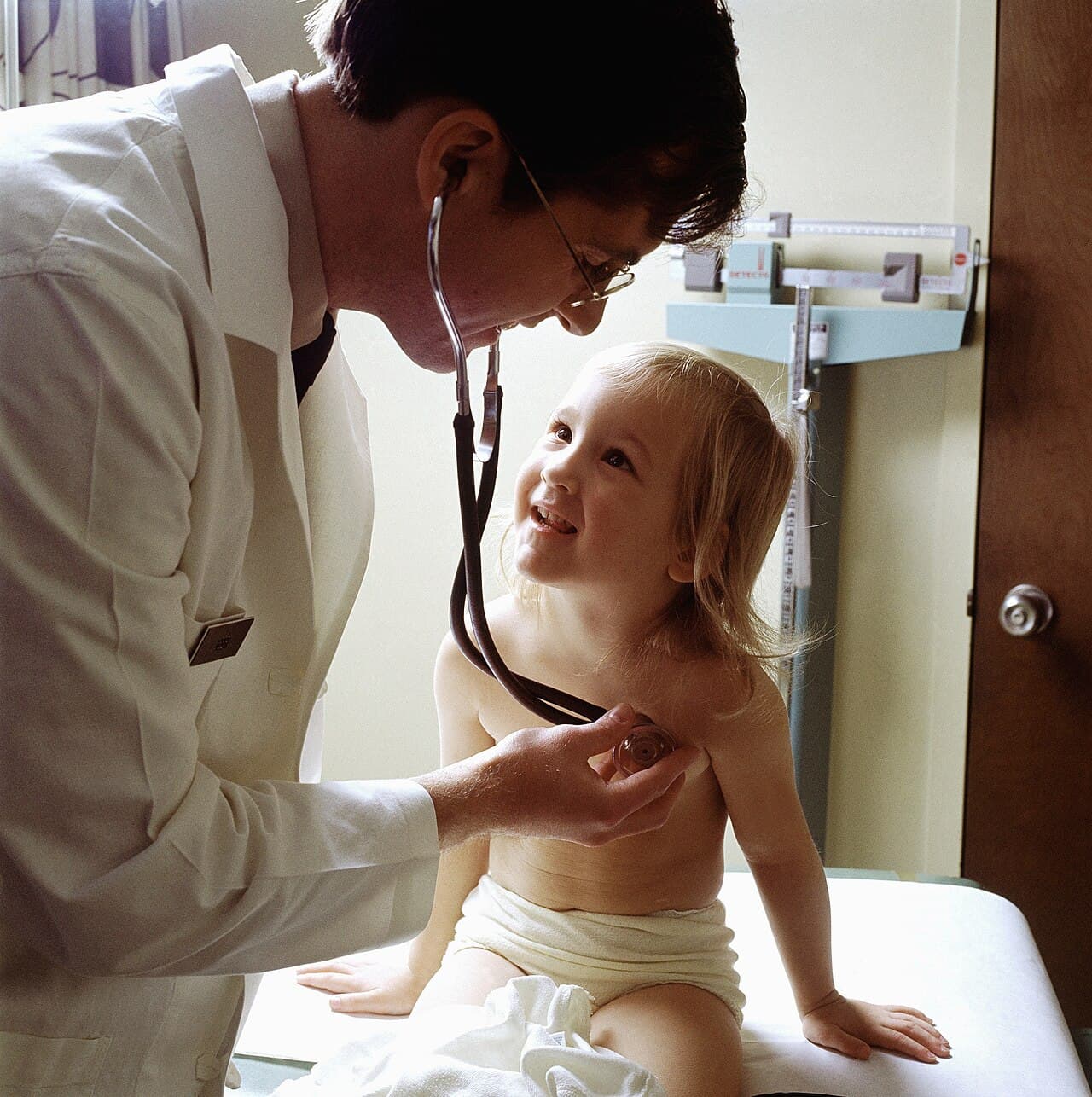 Doctor speaking with a child during a clinic visit