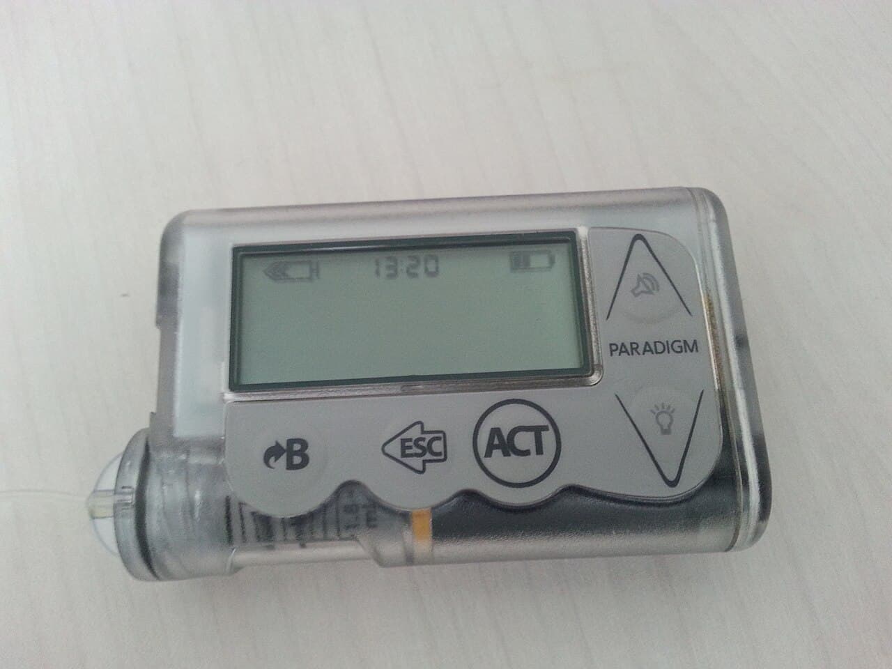 An insulin pump and infusion set arranged on a clean table
