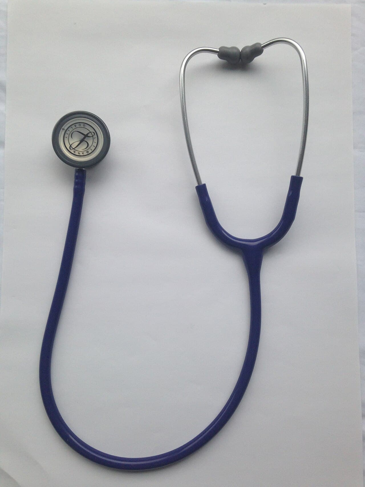 A stethoscope hanging against a clinical background