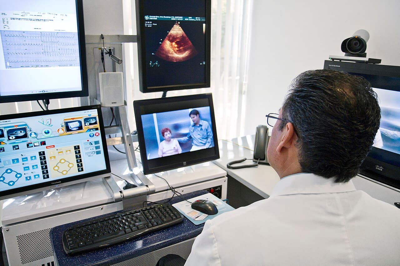 Clinician on a telemedicine consult at a desk, the kind of after-hours video call many Australians now use