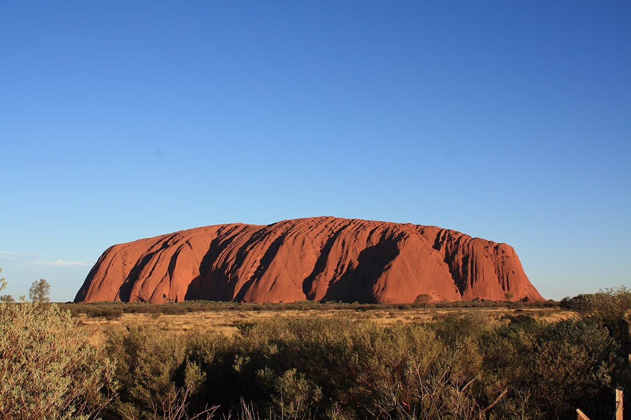 Uluru at dusk from a public viewing area, a landmark many remote retrieval and visiting-service routes pass