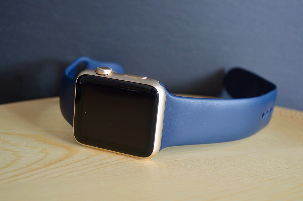 A person checking a health tracking watch on their wrist during a morning walk